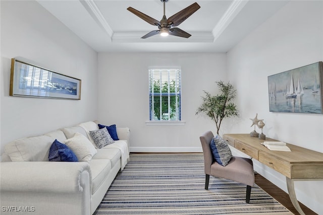 office area with ceiling fan, crown molding, a raised ceiling, and hardwood / wood-style floors