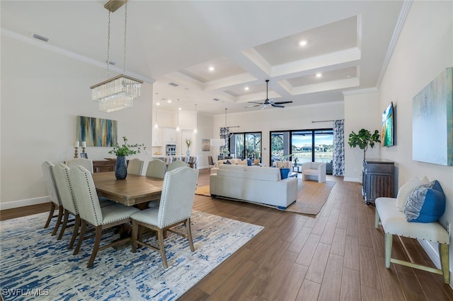 dining room with a towering ceiling, wood-type flooring, coffered ceiling, beamed ceiling, and crown molding