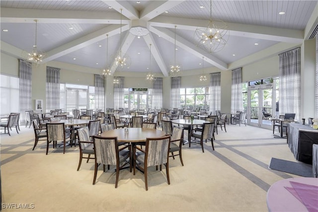 carpeted dining room featuring a chandelier, a high ceiling, and beam ceiling