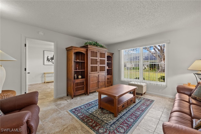 living room with light tile patterned floors and a textured ceiling