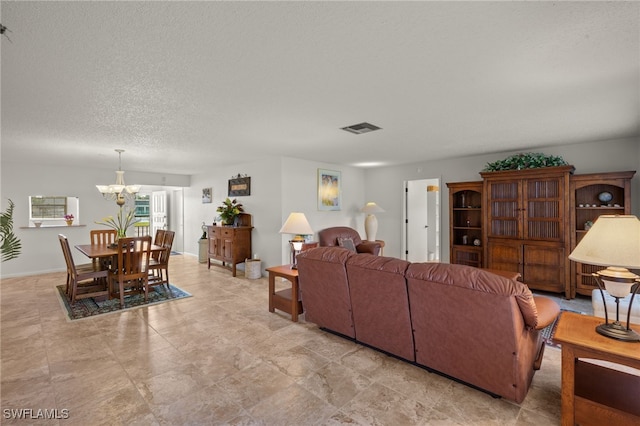 living room featuring a textured ceiling and a notable chandelier