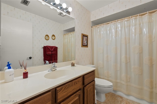 bathroom with vanity, tile patterned flooring, toilet, and walk in shower