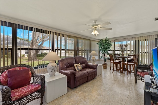 tiled living room featuring ceiling fan