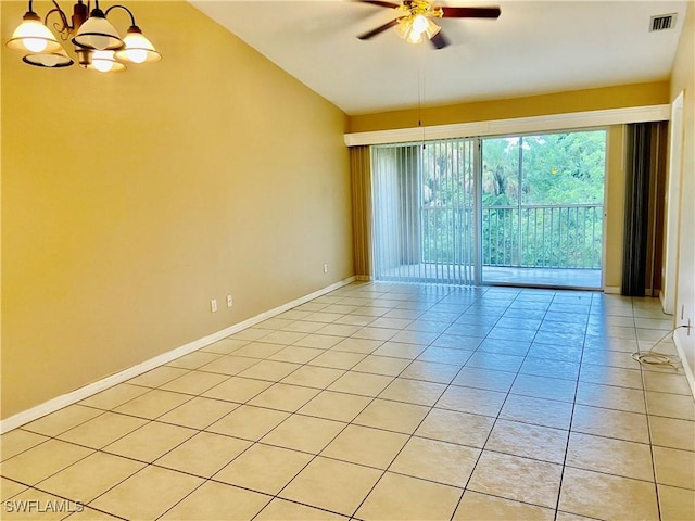 empty room with ceiling fan with notable chandelier, lofted ceiling, and light tile patterned floors