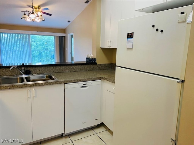 kitchen featuring sink, white cabinetry, vaulted ceiling, light tile patterned floors, and white appliances