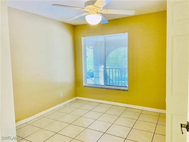 tiled empty room featuring ceiling fan