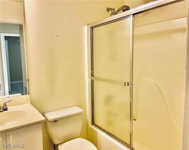 full bathroom with vanity, shower / bath combination with glass door, and toilet