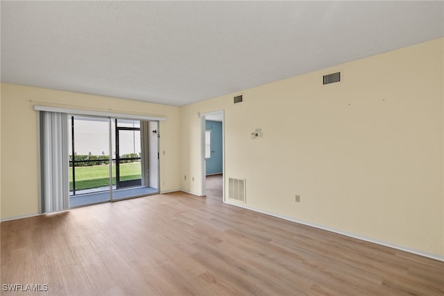 unfurnished room with light hardwood / wood-style floors