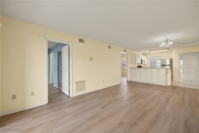 unfurnished living room featuring light hardwood / wood-style flooring