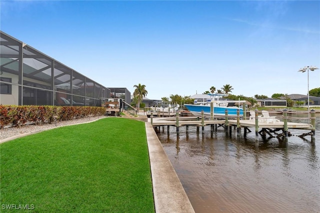 view of dock with a water view, a yard, and glass enclosure