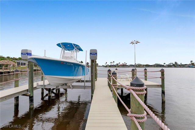 5331 Skyline Blvd, Cape Coral, FL 33914 - dock featuring boat lift and a water view