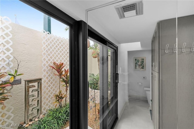 hall with light tile patterned floors