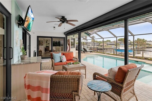 view of swimming pool with a water view and ceiling fan