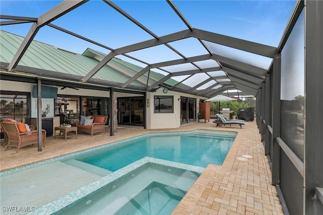 view of pool with an in ground hot tub, a lanai, outdoor lounge area, and a patio