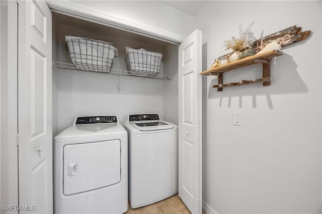 washroom with separate washer and dryer and light tile patterned floors