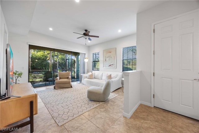 living room featuring a healthy amount of sunlight and ceiling fan