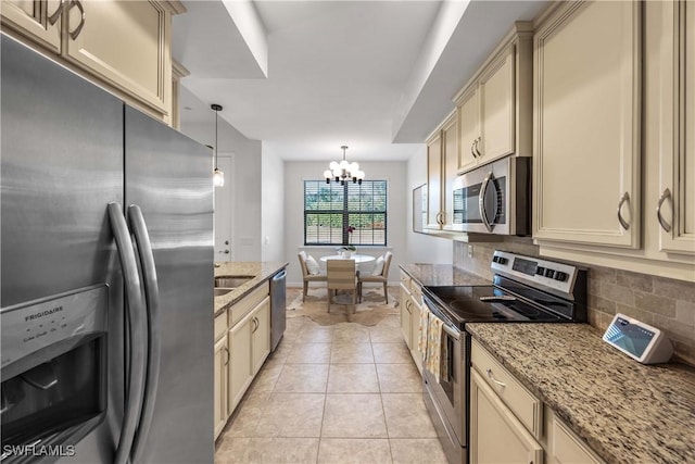 kitchen featuring pendant lighting, light tile patterned floors, stainless steel appliances, light stone countertops, and decorative backsplash