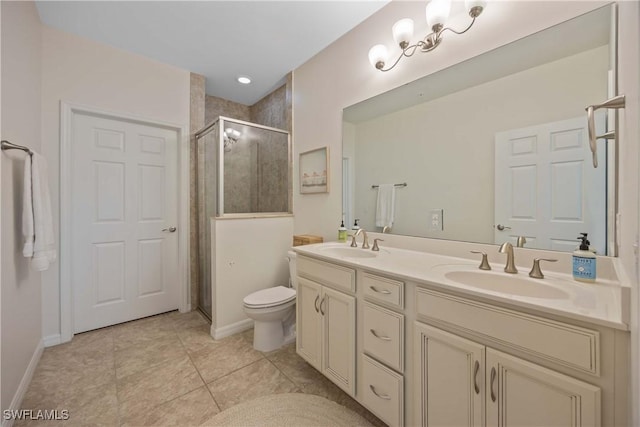 bathroom with vanity, a shower with shower door, tile patterned floors, and toilet