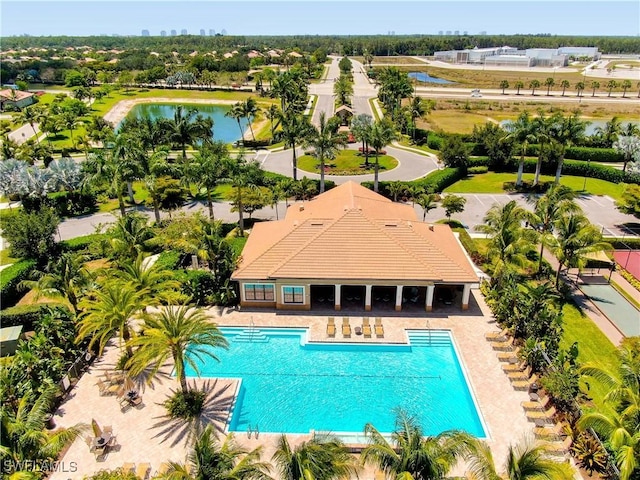 view of swimming pool with a water view and a patio area