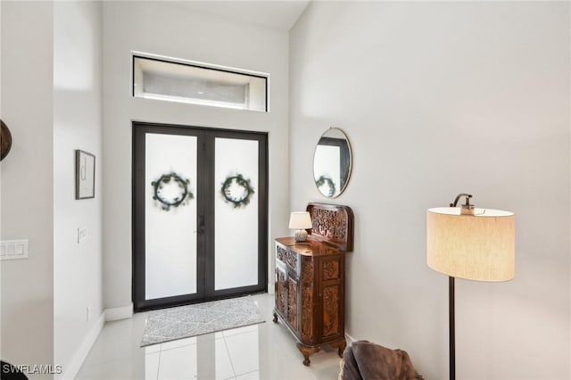 tiled entrance foyer featuring french doors