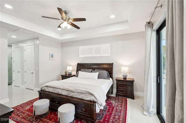 bedroom featuring a raised ceiling and ceiling fan