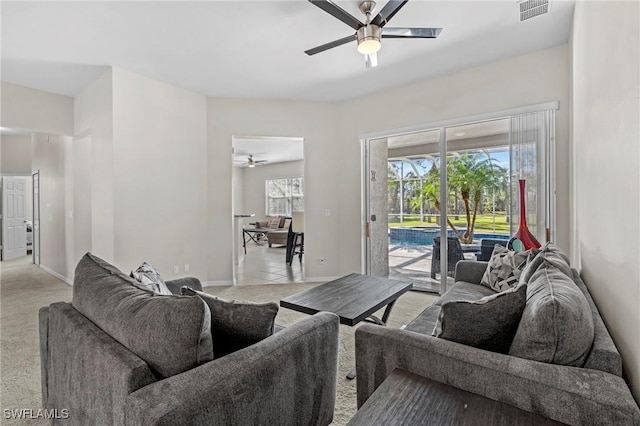 living room featuring light carpet and ceiling fan