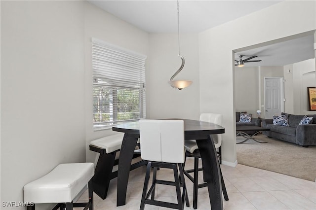 dining room featuring light colored carpet and ceiling fan