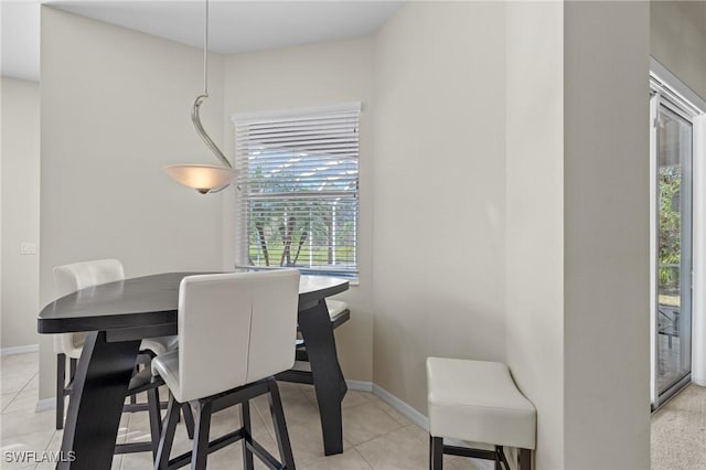 dining space featuring light tile patterned floors