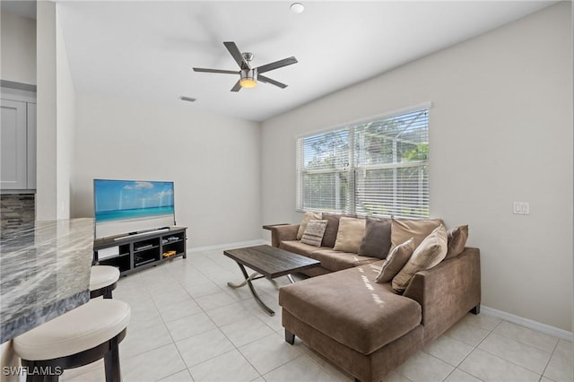 living room featuring light tile patterned floors and ceiling fan