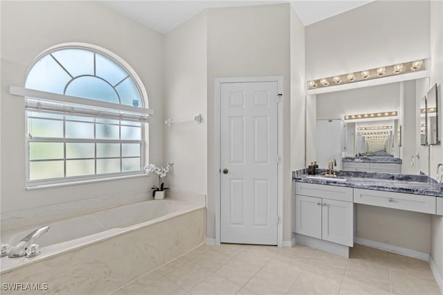 bathroom featuring tile patterned flooring, vanity, and a bath