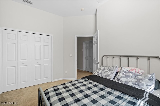 bedroom featuring light colored carpet and a closet