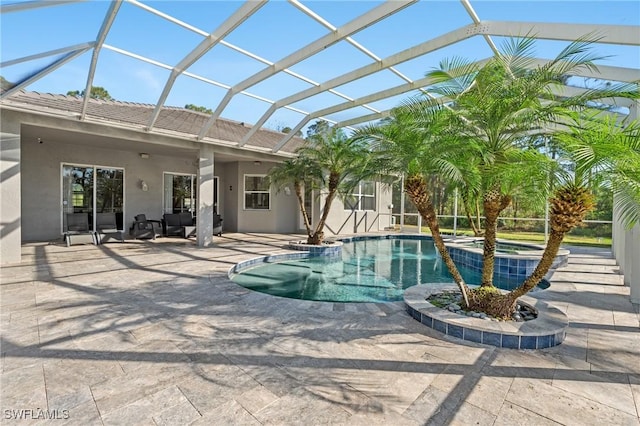 view of swimming pool featuring an in ground hot tub, a patio, and glass enclosure