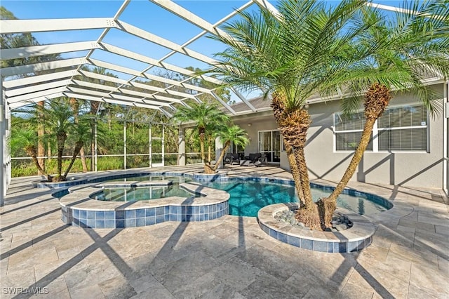 view of pool with an in ground hot tub, a lanai, and a patio