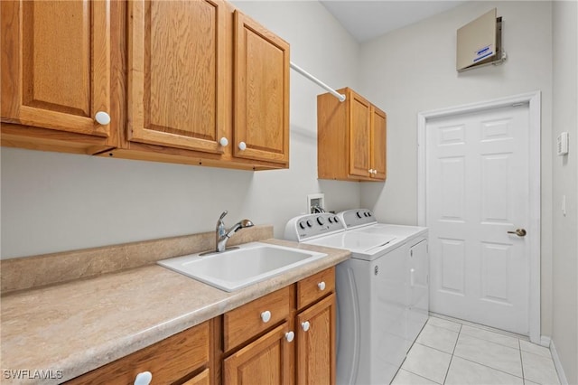 laundry area featuring cabinets, independent washer and dryer, sink, and light tile patterned floors