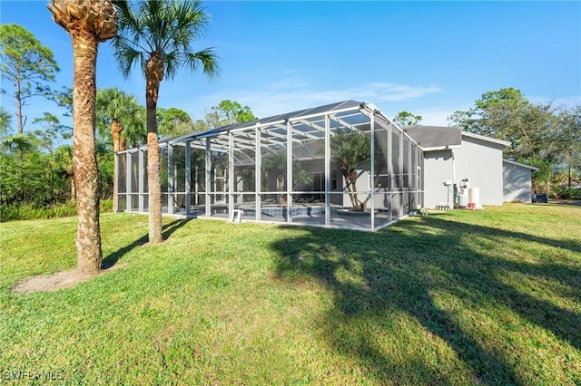 back of house featuring a yard, a lanai, and a patio