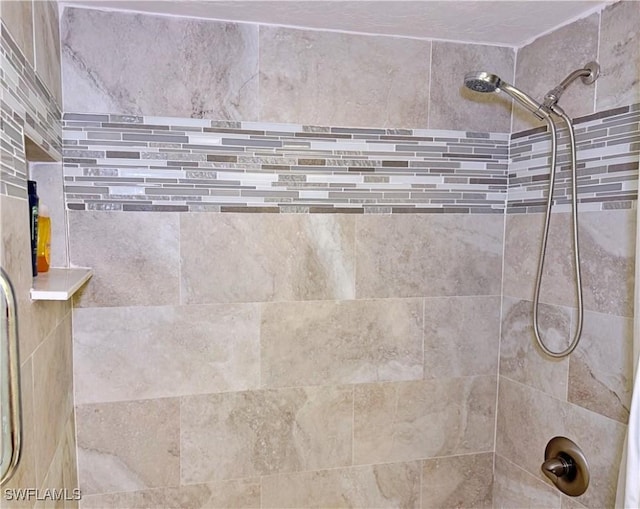 interior details with a tile shower