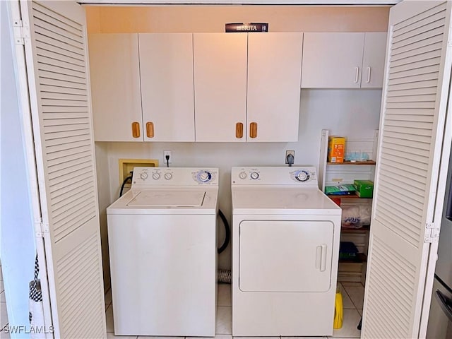 laundry room with cabinets and washer and dryer