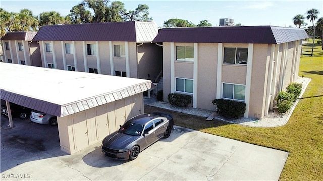 view of front of property featuring a front yard and central air condition unit