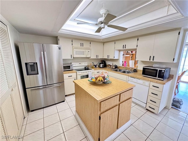 kitchen featuring sink, light tile patterned flooring, a center island, and appliances with stainless steel finishes