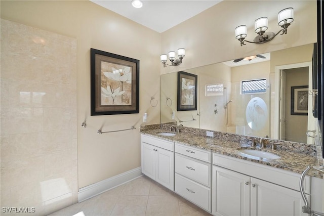 bathroom featuring tile patterned flooring, vanity, and tiled shower