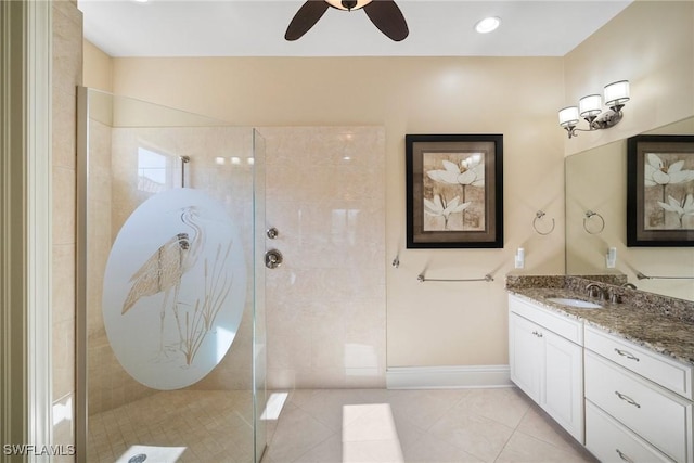 bathroom with vanity, tile patterned floors, and a tile shower