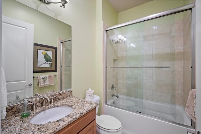 full bathroom featuring vanity, toilet, and combined bath / shower with glass door