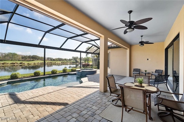 view of patio / terrace featuring a swimming pool with hot tub, ceiling fan, a water view, and glass enclosure