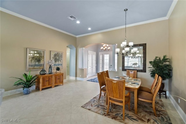 tiled dining area featuring ornamental molding and a chandelier