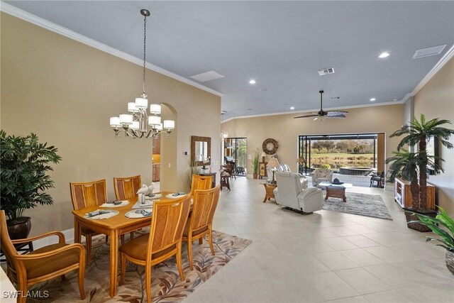 tiled dining space featuring ceiling fan and ornamental molding