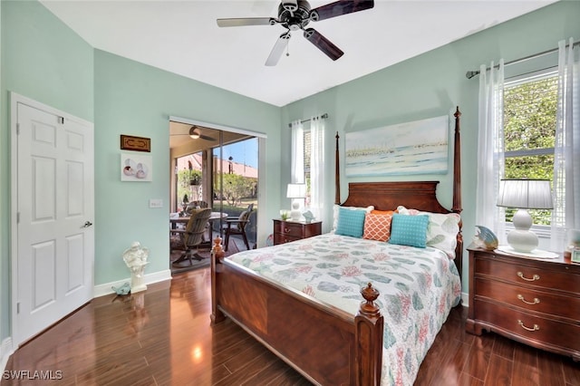 bedroom featuring multiple windows, access to exterior, and dark hardwood / wood-style flooring