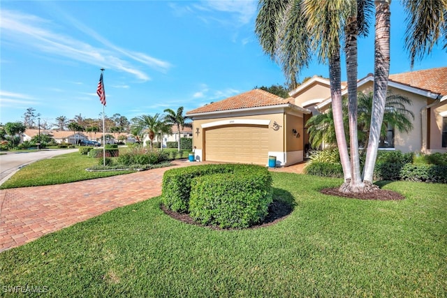 view of front of property featuring a garage and a front yard