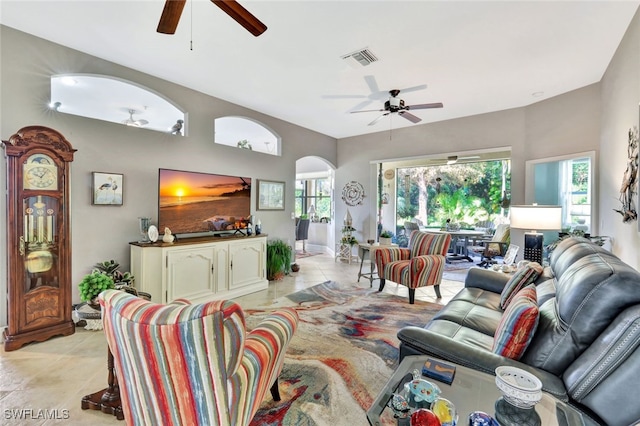 tiled living room featuring plenty of natural light and ceiling fan