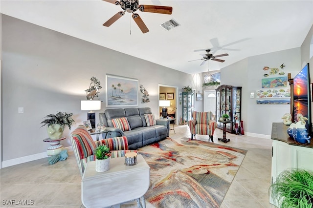 living room featuring ceiling fan, vaulted ceiling, and light tile patterned floors