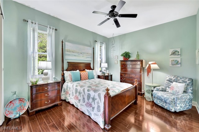 bedroom with dark hardwood / wood-style floors and ceiling fan